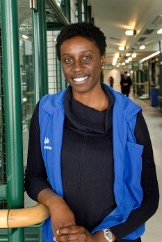 SickKids Volunteer Paula smiling for her picture in a SickKids vest