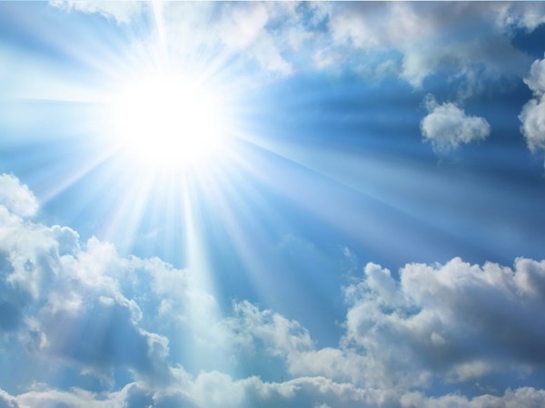 The image shows a bright sun shining through white clouds in a blue sky. Sunrays are visible radiating outward from the sun, creating a dramatic sunburst effect through the cloud formations.RetryClaude can make mistakes. Please double-check responses.