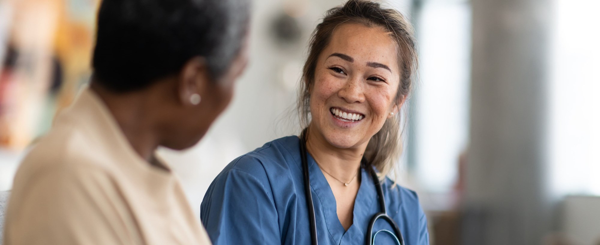 2 smiling medical colleagues in discussion